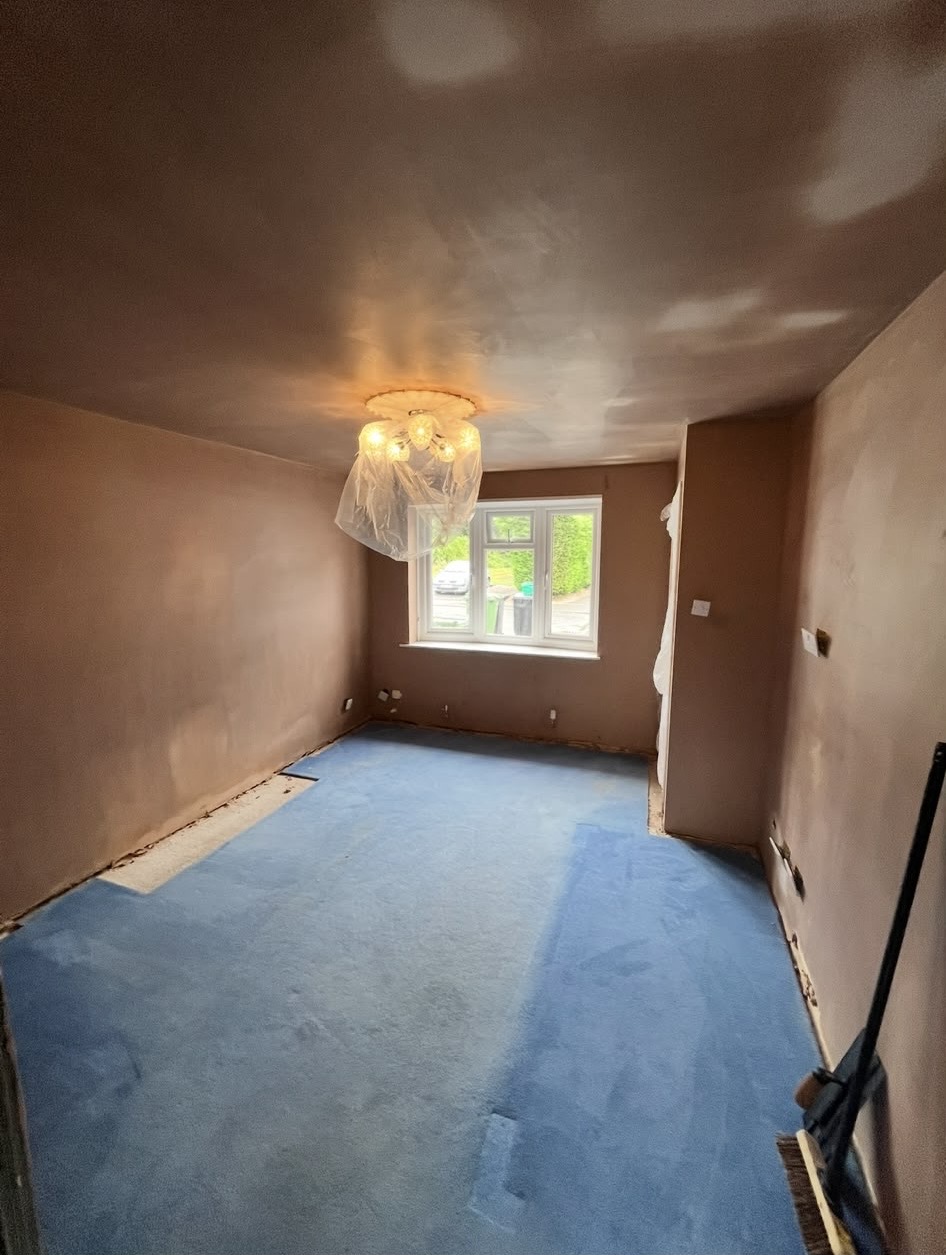 A full room freshly plastered across its walls and ceiling